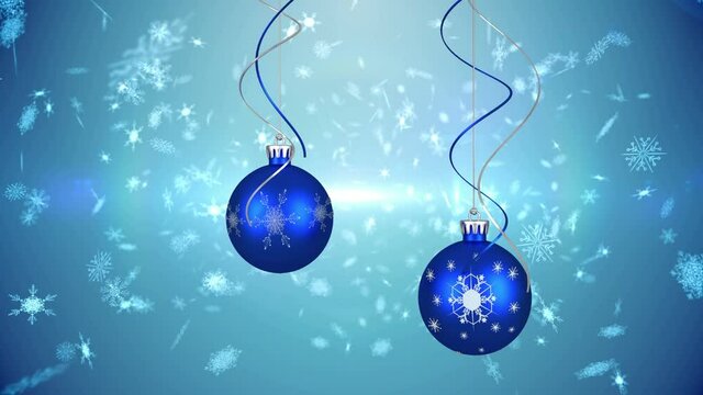 Animation of candy canes, christmas boubles and snow falling over blue background