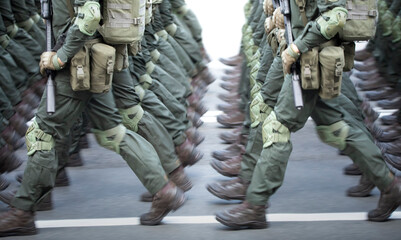 The soldiers' legs are dressed in ankle boots and camouflage pants.