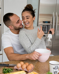 couple enjoying healthy breakfast while sitting in the kitchen at home
