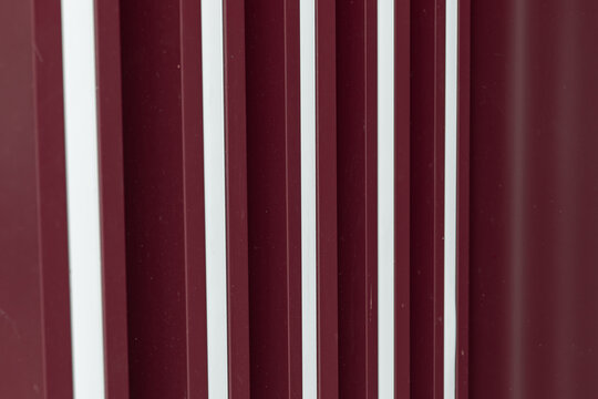 grunge background. wall with red burgundy metal with white accents. Texture for background and design.