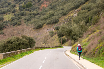 Fototapeta na wymiar Pilgrim Girl Hiking outside Villafranca del Bierzo Spain along the Way of St James Pilgrimage Trail Camino de Santiago