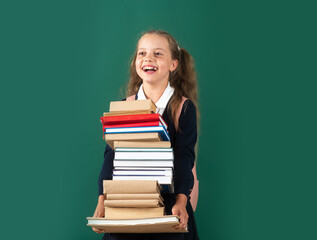 Happy teenage school child hold books green background, knowledge day.