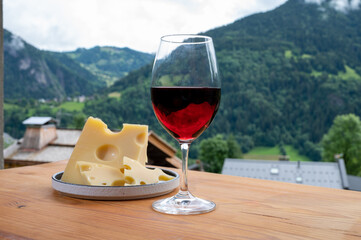 Cheese collection, French cow cheese emmental, glass of red wine from Savoie and french mountains...