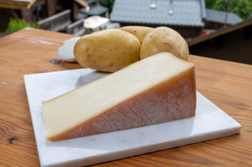 Tastes of Savoia, French cow cheese for gratin abondance, potatoes and french mountains village in...