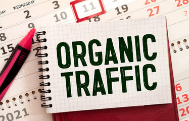 The word ORGANIC TRAFFIC written in red on a black and white background near the pen