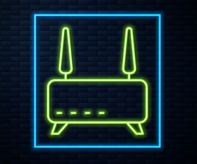 Glowing neon line Router and wi-fi signal icon isolated on brick wall background. Wireless ethernet modem router. Computer technology internet. Vector