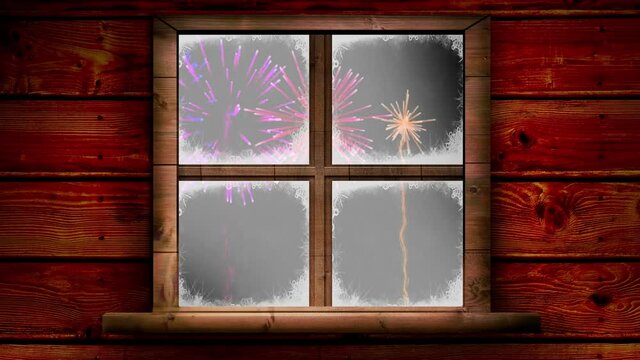Wooden window frame against colorful fireworks exploding on black background