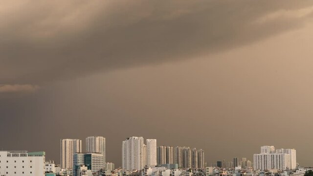 afternoon thunderstorm to night rain time lapse in dramatic golden light and illuminated generic modern urban high-rise development area.