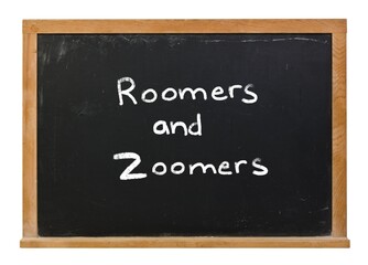 Roomers and zoomers written in white chalk on a black chalkboard isolated on white