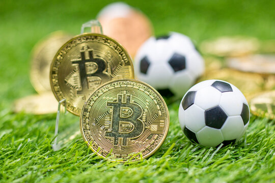 Soccer ball and Bitcoin on green grass. crypto awareness across Europe.