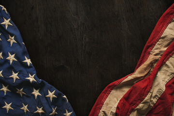 Vintage US American flag crumpled on worn wooden background. Blank copy space for text. For USA Memorial day, Veterans day, 4th of July, or other patriotic holiday.