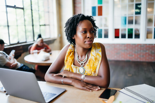 Woman working on laptop at coworking modern office