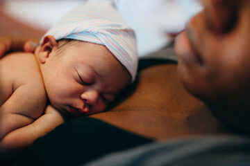 Black mother and son bonding with skin to skin time