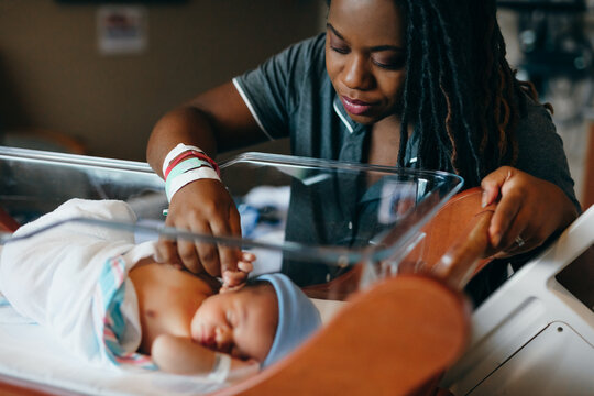 Black mom checks on newborn son at hospital 