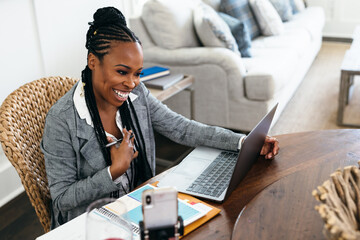 Black woman working from home on virtual meeting video chat