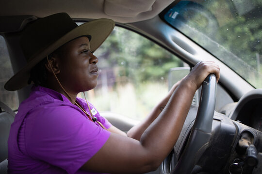 Female farmer in hat driving car