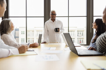 Senior African American woman leading business team meeting