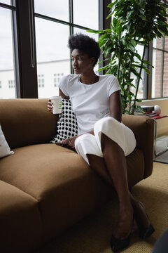 Business woman sitting on sofa in office