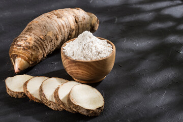 Taro Root of Colocasia esculenta and Organic Taro Flour in a bowl