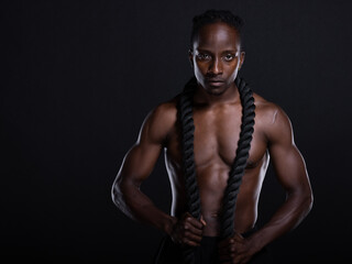 Fit African American man with muscles posing in studio