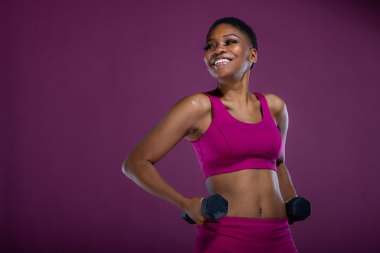 Black woman workout with dumbbells and copy-space