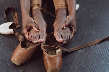 Black ballerina dancer takes off pointe shoes, pushing through pain, perseverance 