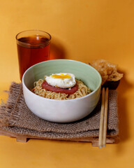 Noodle dumplings in a bowl with beef, egg and sausage toppings. Perfect for your lunch menu. Noodle dumplings come from China. Dumpling noodle mockup. Focus blur.