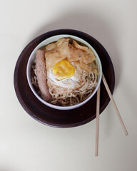 Noodle dumplings in a bowl with beef, egg and sausage toppings. Perfect for your lunch menu. Noodle dumplings come from China. Dumpling noodle mockup. Focus blur.