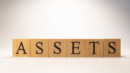 The word Assets was created from wooden cubes. economy and business.