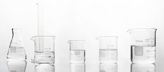glass flask and beaker chemistry science research lab white banner background.