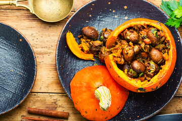 Tasty autumn stuffed pumpkin with mushrooms