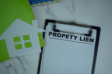 Property Lien write on a paperwork isolated on Wooden Table.