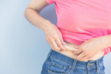 Women catch excess fat. Weight loss after effective diet and regular exercise. health care concept.
