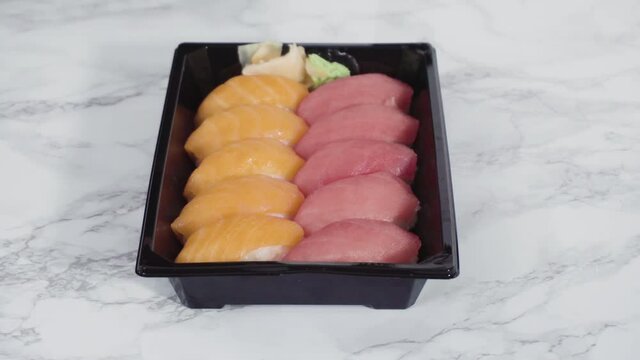 Pre-packaged sushi in a plastic tray.