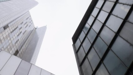 City skyscrapers low angle with sky. The corporate buildings create an imposing claustrophobic skyscape