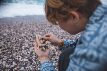 Girl holds small pebbles on her palm
