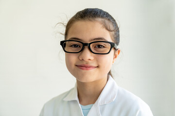 Child girl scientists learning science wearing white uniform and glasses in classroom or laboratory. Early development of children. Medical, Lab, Scientific experiment, Researcher, Research concept