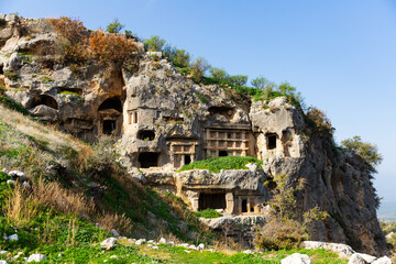 View of antique rock burial chambers in ancient Lycian city of Tlos in Turkey. Examples of ancient rock cut architecture