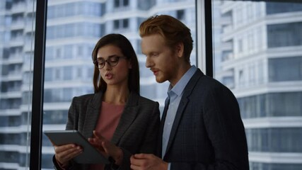 Business people using tablet computer in office. business partners talking  - Powered by Adobe