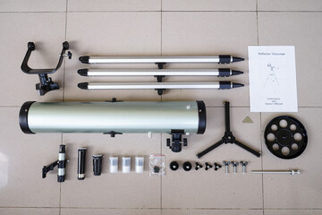 All package included. Telescope parts on wooden table. Astronomy lesson exploring parts of telescope.