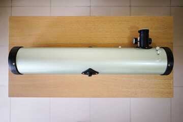 Reflector Optical Tube Assembly Telescobe Tube. Telescope parts on wooden table. Astronomy lesson...