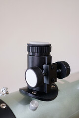 Rack and pinion focuser. Telescope parts on wooden table. Astronomy lesson exploring parts of...