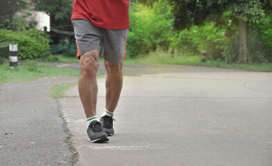 an old man legs and muscles while running along the street, concept elderly people health care