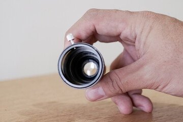 Barlow lens 2x for magnify. Telescope parts on wooden table. Astronomy lesson exploring parts of...