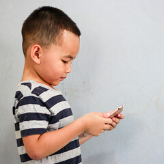 asian children watching tablet. playing phone and looking at cartoon. boy playing with digital tablet