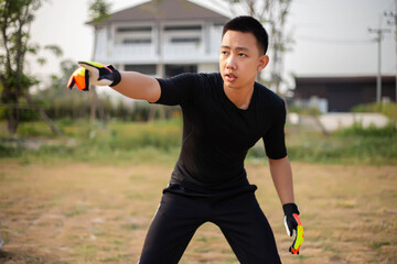 Sports and recreation concept a male goalkeeper standing in front of the goal throwing a ball as...