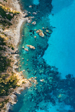 View from above, stunning aerial view of a green and rocky coastline bathed by a turquoise, crystal clear water. Costa Smeralda, Sardinia, Italy. © Travel Wild