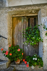 Fototapeta na wymiar The entrance door to a characteristic house in a small town in the mountains of the province of Potenza, Italy.