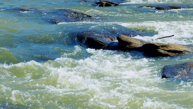 Slow motion rapids with rocks