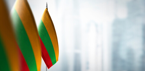 Small flags of Lithuania on the background of a blurred background - obrazy, fototapety, plakaty